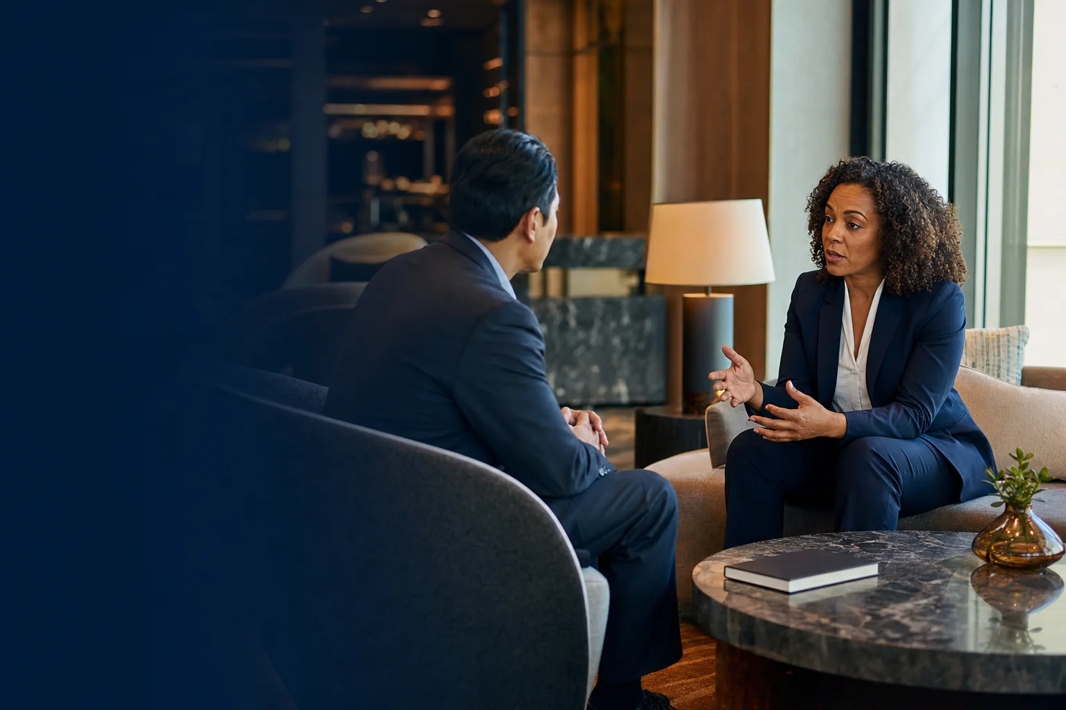 Hospitality leaders holding a focused conversation in a hotel lobby
